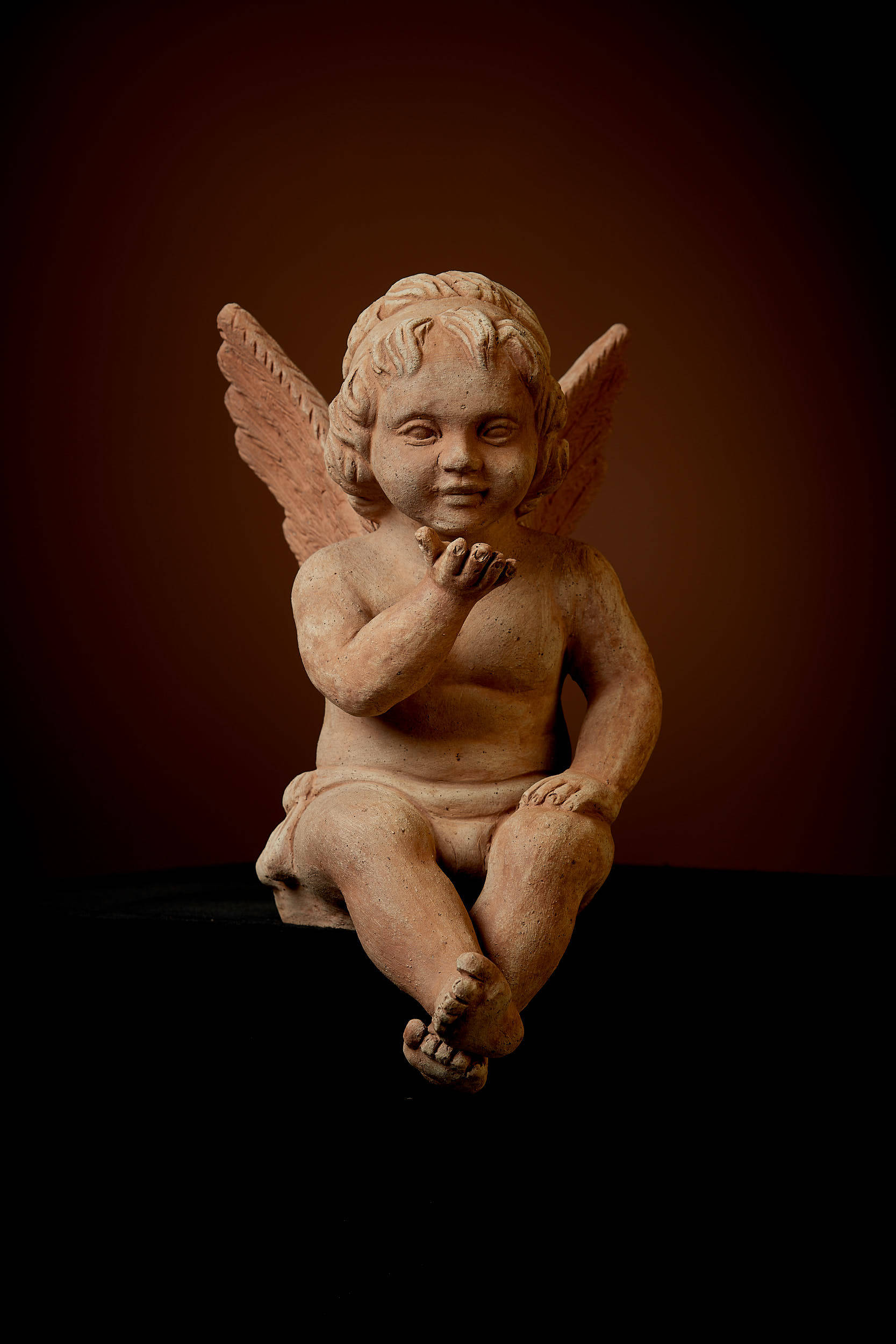 Putto, sitzend